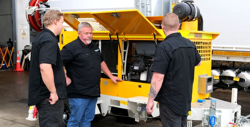 PS Equipment team reviewing a custom-built pump truck chassis.