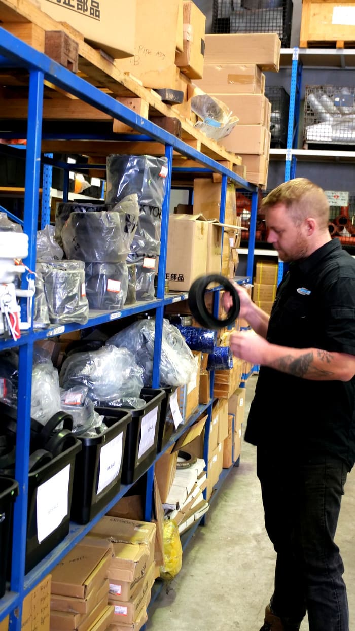 PS Equipment staff picking a genuine seal from the parts store