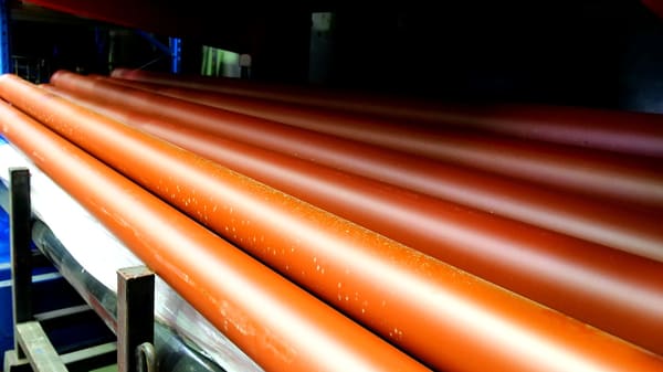 Genuine orange concrete pump delivery pipes on the rack